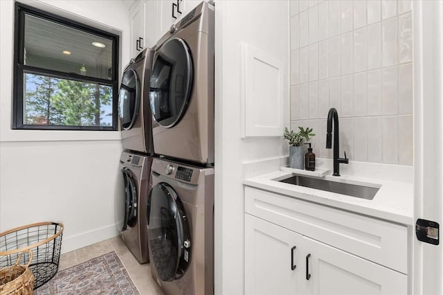 9610 S Mullen Hill Rd, Spokane, WA 99224 - laundry area featuring stacked washer / drying machine, cabinet space, and baseboards