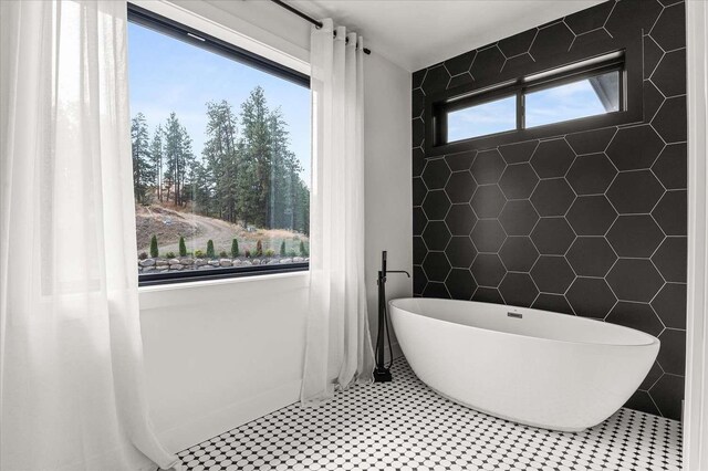 9610 S Mullen Hill Rd, Spokane, WA 99224 - bathroom featuring a freestanding tub and tile walls