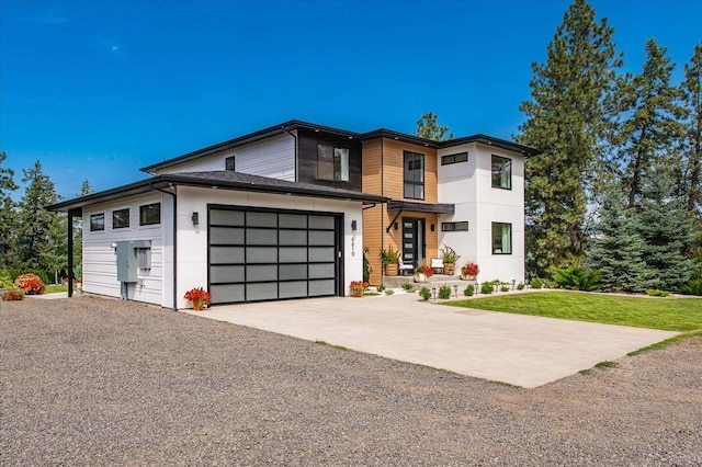 9610 S Mullen Hill Rd, Spokane, WA 99224 - contemporary home featuring concrete driveway, stucco siding, and a front yard