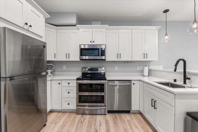 9610 S Mullen Hill Rd, Spokane, WA 99224 - kitchen with appliances with stainless steel finishes, a sink, light countertops, and white cabinetry
