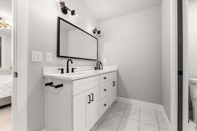 9610 S Mullen Hill Rd, Spokane, WA 99224 - full bath featuring marble look tiles, double vanity, baseboards, and toilet