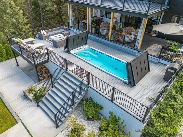 9610 S Mullen Hill Rd, Spokane, WA 99224 - view of swimming pool featuring an outdoor hangout area, stairway, and a wooden deck