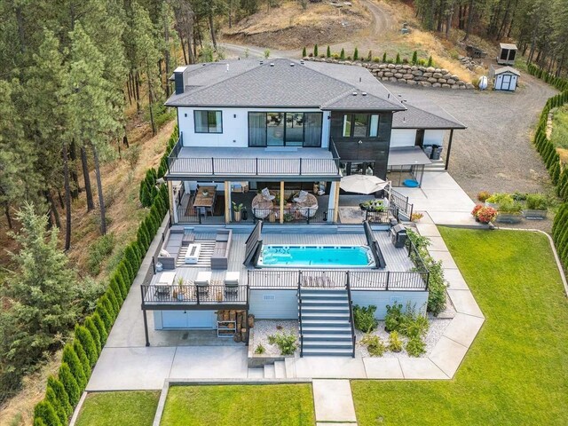 9610 S Mullen Hill Rd, Spokane, WA 99224 - back of property featuring stairway, a balcony, a yard, an outdoor pool, and a patio area