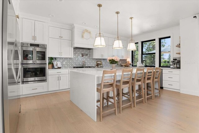 9610 S Mullen Hill Rd, Spokane, WA 99224 - kitchen with appliances with stainless steel finishes, light wood-style flooring, tasteful backsplash, white cabinetry, and recessed lighting
