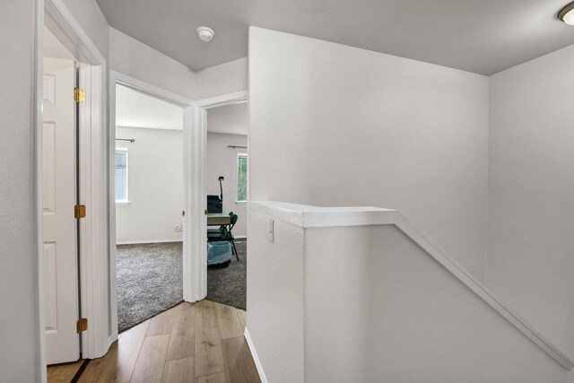 11212 E 4th Ave Unit D, Spokane Valley, WA 99206 - corridor with an upstairs landing, wood finished floors, and baseboards