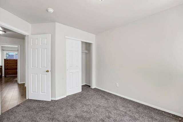 11212 E 4th Ave Unit D, Spokane Valley, WA 99206 - unfurnished bedroom with carpet floors, baseboards, and a closet