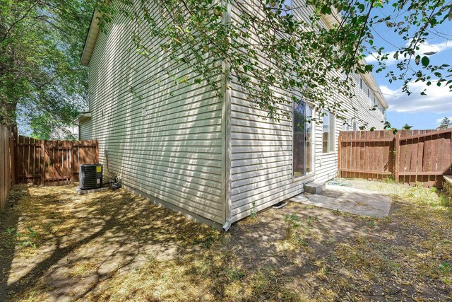 11212 E 4th Ave Unit D, Spokane Valley, WA 99206 - view of side of home featuring a fenced backyard and central AC