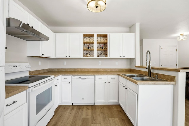 11212 E 4th Ave Unit D, Spokane Valley, WA 99206 - kitchen with white appliances, ventilation hood, a peninsula, a sink, and light wood-type flooring