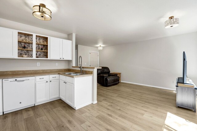 11212 E 4th Ave Unit D, Spokane Valley, WA 99206 - kitchen featuring white dishwasher, a sink, a peninsula, and light wood-style flooring