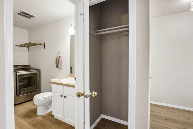 11212 E 4th Ave Unit D, Spokane Valley, WA 99206 - half bathroom featuring washer / clothes dryer, vanity, toilet, and wood finished floors