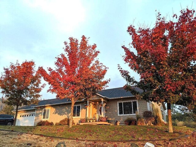 633C Garvey Rd, Colville, WA 99114 - ranch-style house with an attached garage and a front lawn
