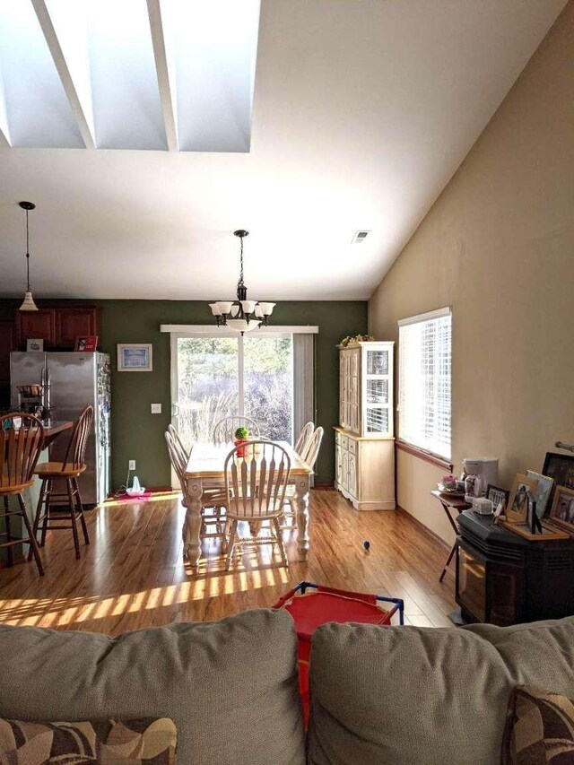 633C Garvey Rd, Colville, WA 99114 - living room with vaulted ceiling, light wood-style flooring, and a chandelier