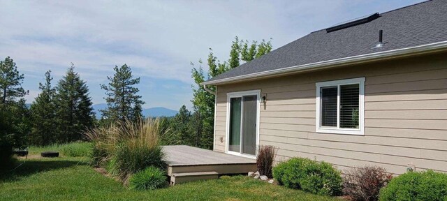 633C Garvey Rd, Colville, WA 99114 - view of property exterior featuring a deck and a lawn