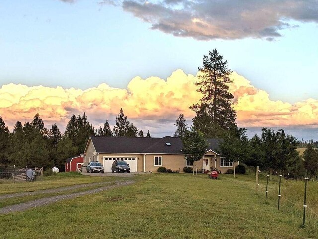 633C Garvey Rd, Colville, WA 99114 - single story home with driveway, an attached garage, and a lawn