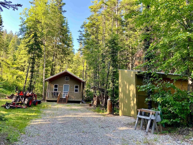 TBD Buck Creek Rd, Newport, WA 99156 - view of front facade featuring a view of trees, an outdoor structure, and a wooden deck