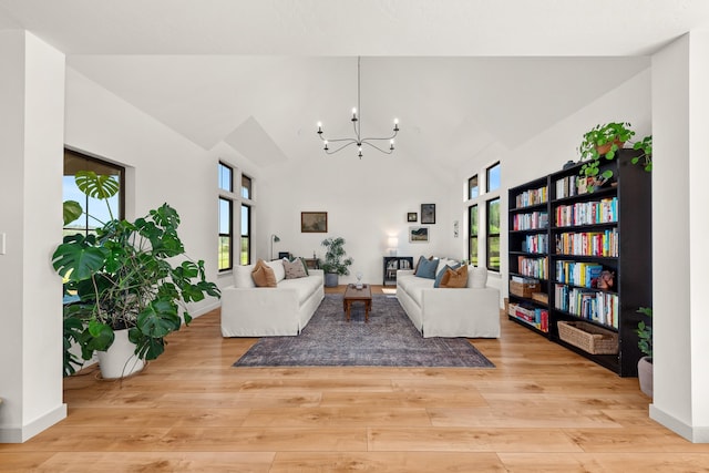 16106 N Mt Spokane Park Dr, Mead, WA 99021 - living room featuring a chandelier, light wood-style floors, high vaulted ceiling, and baseboards