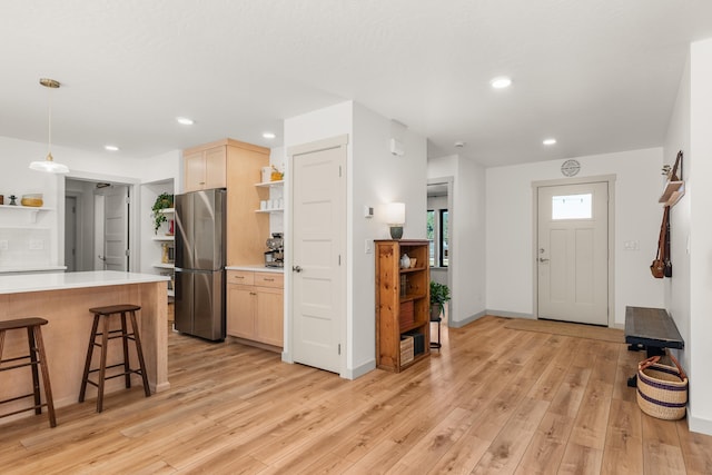 16106 N Mt Spokane Park Dr, Mead, WA 99021 - kitchen with open shelves, freestanding refrigerator, a breakfast bar, light wood-style floors, and recessed lighting