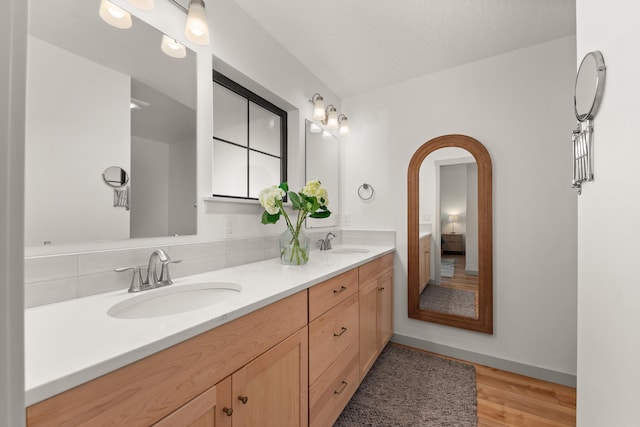 16106 N Mt Spokane Park Dr, Mead, WA 99021 - full bathroom with double vanity, wood finished floors, and baseboards