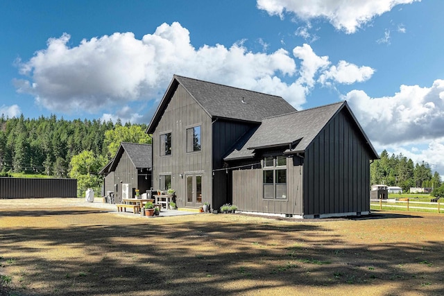 16106 N Mt Spokane Park Dr, Mead, WA 99021 - rear view of house with board and batten siding, a shingled roof, and a patio area