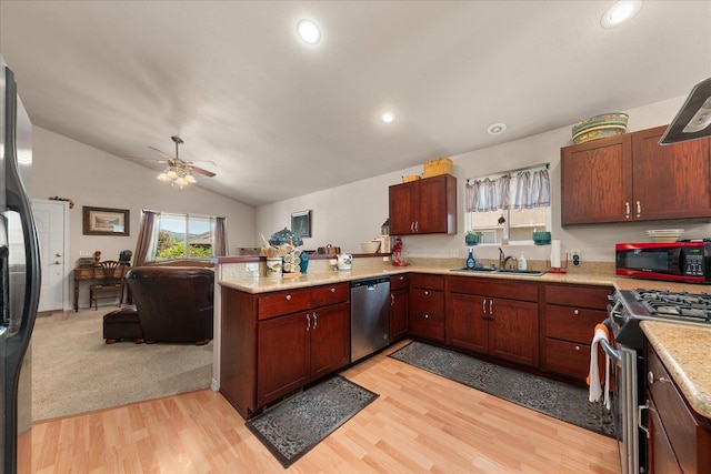 813 Tamarack Ln, Chewelah, WA 99109 - kitchen featuring appliances with stainless steel finishes, a sink, a peninsula, light countertops, and open floor plan