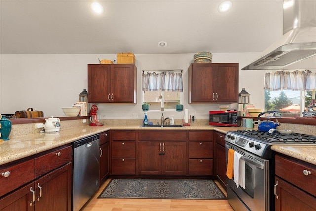 813 Tamarack Ln, Chewelah, WA 99109 - kitchen with stainless steel appliances, wall chimney range hood, a sink, healthy amount of natural light, and recessed lighting