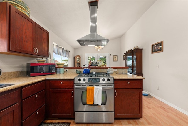 813 Tamarack Ln, Chewelah, WA 99109 - kitchen with stainless steel gas range, island range hood, a peninsula, light wood-style floors, and light countertops
