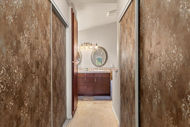 813 Tamarack Ln, Chewelah, WA 99109 - hall with light colored carpet, lofted ceiling, a sink, and baseboards