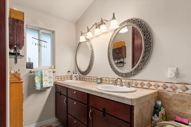 813 Tamarack Ln, Chewelah, WA 99109 - bathroom featuring double vanity and lofted ceiling