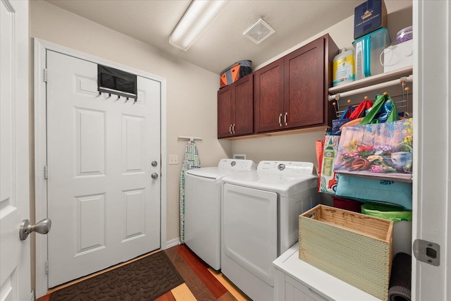 813 Tamarack Ln, Chewelah, WA 99109 - washroom featuring washer and dryer, dark wood-type flooring, and cabinet space