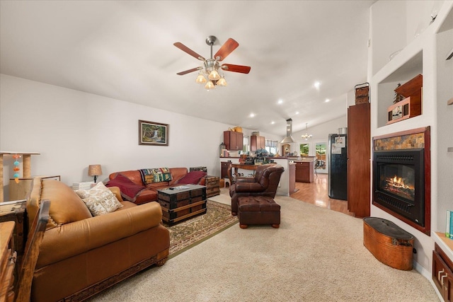 813 Tamarack Ln, Chewelah, WA 99109 - living room featuring ceiling fan, lofted ceiling, a glass covered fireplace, and light carpet