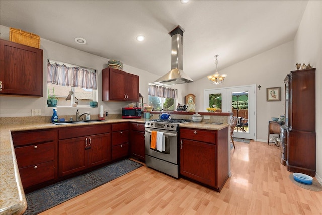813 Tamarack Ln, Chewelah, WA 99109 - kitchen featuring a sink, island exhaust hood, gas range, light countertops, and a peninsula