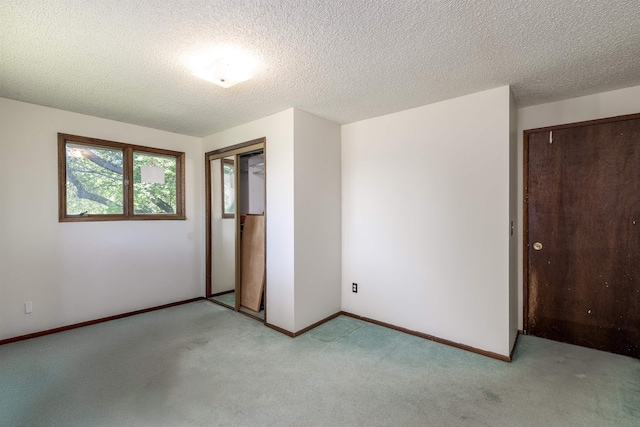24615 E Joseph Ave, Otis Orchards, WA 99027 - unfurnished bedroom with light carpet, a textured ceiling, baseboards, and a closet