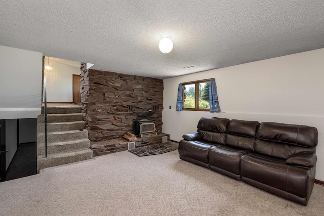 24615 E Joseph Ave, Otis Orchards, WA 99027 - living room featuring carpet floors, a wood stove, a textured ceiling, stairs, and baseboards