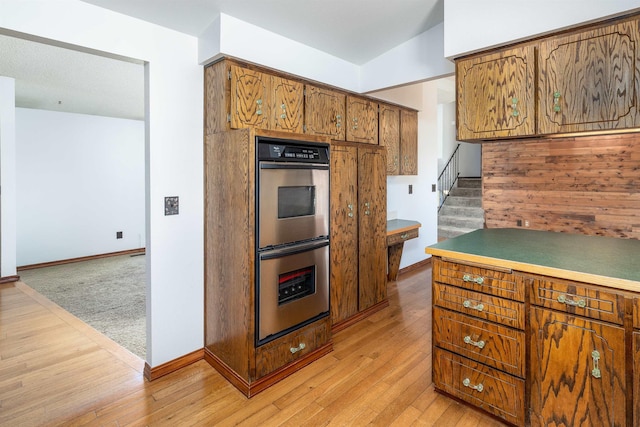24615 E Joseph Ave, Otis Orchards, WA 99027 - kitchen with stainless steel double oven, brown cabinetry, and baseboards