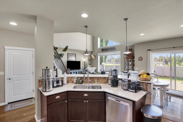 726 E Colbert Rd, Colbert, WA 99005 - kitchen featuring stainless steel dishwasher, wood finished floors, dark brown cabinets, light countertops, and hanging light fixtures