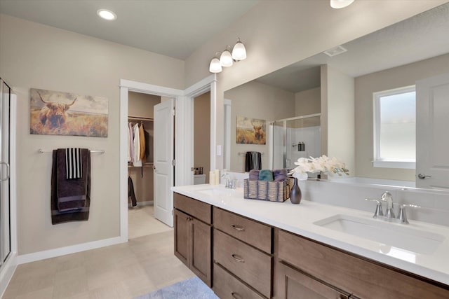 18381 E 17th Ave, Greenacres, WA 99016 - bathroom featuring a shower stall, double vanity, a walk in closet, and tile patterned floors