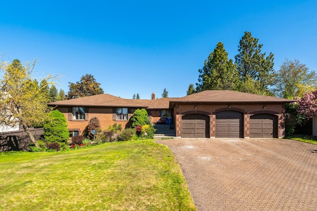 1621 E 65th Ave, Spokane, WA 99223 - single story home featuring a garage, brick siding, decorative driveway, a front lawn, and a chimney