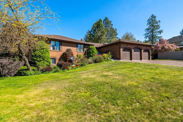 1621 E 65th Ave, Spokane, WA 99223 - view of front facade with a garage, asphalt driveway, and brick siding