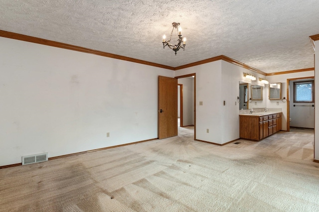1621 E 65th Ave, Spokane, WA 99223 - unfurnished living room with a chandelier, light colored carpet, crown molding, and a textured ceiling