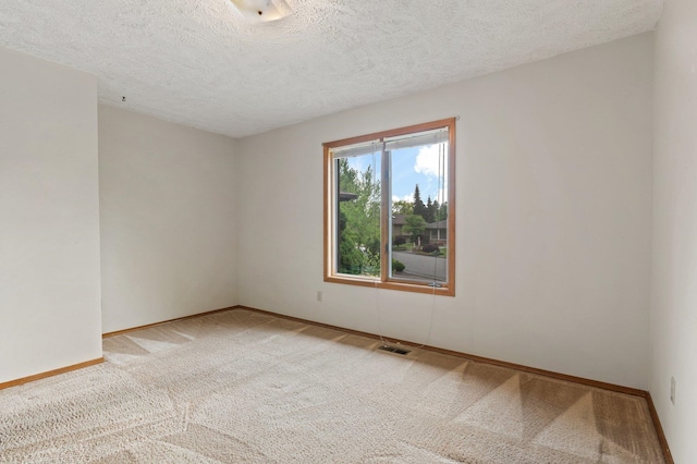1621 E 65th Ave, Spokane, WA 99223 - carpeted empty room with a textured ceiling and baseboards