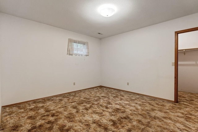 1621 E 65th Ave, Spokane, WA 99223 - unfurnished bedroom featuring carpet flooring, a closet, and a walk in closet