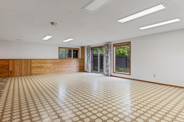 1621 E 65th Ave, Spokane, WA 99223 - spare room featuring wood walls and baseboards