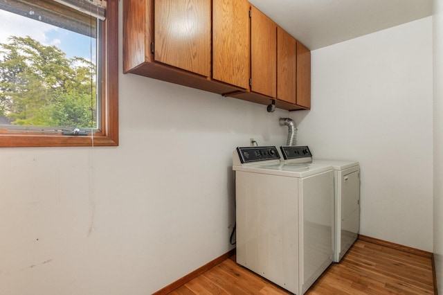 1621 E 65th Ave, Spokane, WA 99223 - washroom with cabinet space, washer and clothes dryer, and light wood-style floors