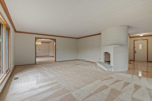 1621 E 65th Ave, Spokane, WA 99223 - unfurnished living room featuring a chandelier, light colored carpet, ornamental molding, and a brick fireplace