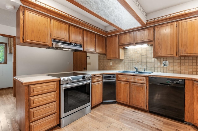 1621 E 65th Ave, Spokane, WA 99223 - kitchen featuring stainless steel electric range, black dishwasher, under cabinet range hood, and light wood-type flooring