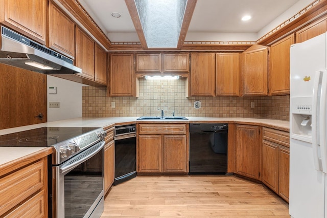 1621 E 65th Ave, Spokane, WA 99223 - kitchen with white refrigerator with ice dispenser, dishwasher, stainless steel range with electric stovetop, under cabinet range hood, and light countertops