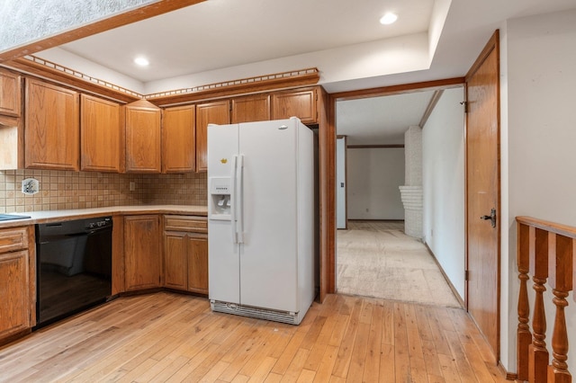 1621 E 65th Ave, Spokane, WA 99223 - kitchen with white refrigerator with ice dispenser, dishwasher, brown cabinets, and recessed lighting