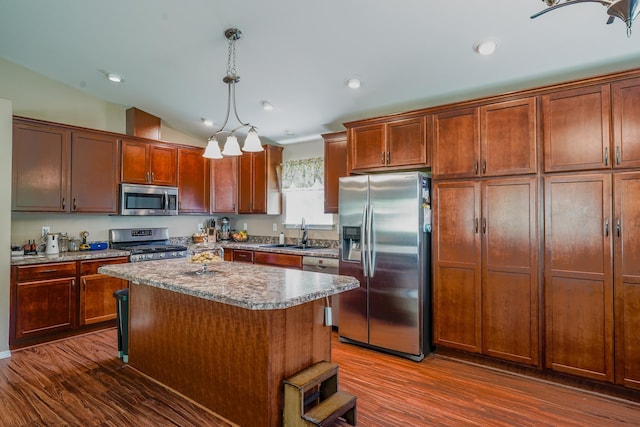 38823 N Newport Hwy, Elk, WA 99009 - kitchen with appliances with stainless steel finishes, dark wood-type flooring, vaulted ceiling, a center island, and pendant lighting
