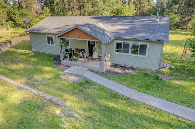 38823 N Newport Hwy, Elk, WA 99009 - view of front of house featuring a patio area, a front lawn, and a shingled roof