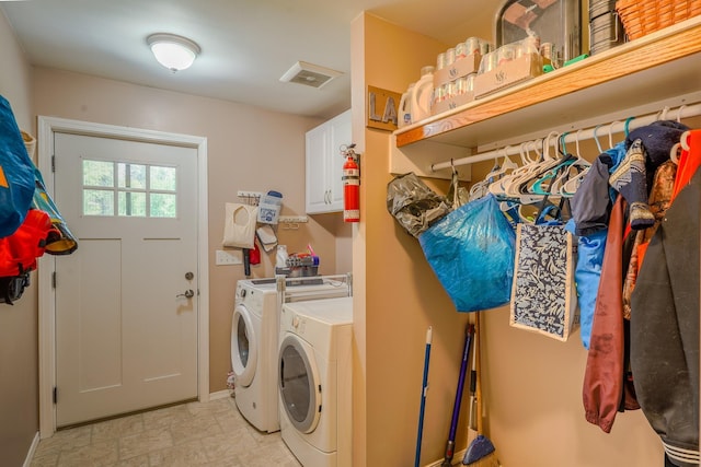 38823 N Newport Hwy, Elk, WA 99009 - laundry room featuring washer and clothes dryer, cabinet space, and light stone finish flooring